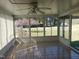 Sunroom with a ceiling fan, tile flooring, and many windows facing the yard at 3226 Powhatan Rd, Clayton, NC 27527