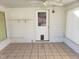 Sunroom featuring a tile floor, white paneled walls, and a back door at 3226 Powhatan Rd, Clayton, NC 27527