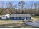 Aerial view of the property showing the house, outbuildings, and a detached garage, all on a large lot at 352 Leonard Rd, Louisburg, NC 27549