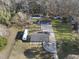 An aerial view of a blue home with outbuildings and trees, showing the expansive property at 352 Leonard Rd, Louisburg, NC 27549