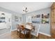 Bright dining room with hardwood floors, wooden table, decorative light fixture, and views of the yard at 352 Leonard Rd, Louisburg, NC 27549