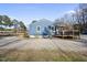 Side view of the blue house, highlighting the back deck and large windows, offering plenty of natural light at 352 Leonard Rd, Louisburg, NC 27549