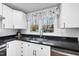 Bright corner of the kitchen featuring stainless steel appliances, granite counters, and a window at 352 Leonard Rd, Louisburg, NC 27549