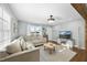 Bright living room with a comfortable sectional sofa and large window at 352 Leonard Rd, Louisburg, NC 27549