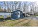 Charming outbuilding with matching paint and convenient carport at 352 Leonard Rd, Louisburg, NC 27549