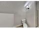 This half-bathroom features a toilet with wood-look floors and is located next to the shower at 3704 Sky Meadow Dr, Apex, NC 27539