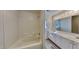This bathroom features a combination bathtub and shower, with a double vanity and wood-look floors at 3704 Sky Meadow Dr, Apex, NC 27539
