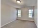 Bright bedroom features two windows with natural light, neutral paint, and carpeted floors at 3704 Sky Meadow Dr, Apex, NC 27539