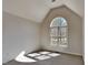 Bedroom features an arched window with natural light, neutral paint, and carpeted floors at 3704 Sky Meadow Dr, Apex, NC 27539