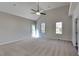 Large primary bedroom with plush carpet, vaulted ceiling, natural light, and an inviting space for relaxation at 3704 Sky Meadow Dr, Apex, NC 27539