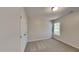 This bright bedroom features a window with natural light, a closet, neutral paint, and carpeted floors at 3704 Sky Meadow Dr, Apex, NC 27539