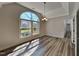 Bright dining room with gray flooring, large window overlooking the yard, and neutral walls creating an open space at 3704 Sky Meadow Dr, Apex, NC 27539