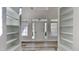 Bright entryway with light gray wood floors, white walls, and symmetrical shelving creating a grand, inviting space at 3704 Sky Meadow Dr, Apex, NC 27539
