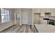Bright eat-in kitchen with gray floors, white cabinets, stainless steel appliances, and an inviting space for cooking at 3704 Sky Meadow Dr, Apex, NC 27539