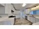 Modern kitchen featuring stainless steel appliances, sleek white cabinets, and white countertops creating a clean, functional space at 3704 Sky Meadow Dr, Apex, NC 27539