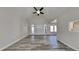 Open concept living room with gray floors, vaulted ceiling, and plenty of natural light creating a bright and airy space at 3704 Sky Meadow Dr, Apex, NC 27539