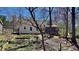 Fenced backyard with garden beds featuring thriving greenery, on a sunny day at 3704 Sky Meadow Dr, Apex, NC 27539