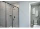 Bright bathroom with a tiled walk-in shower, a toilet in a separate area, and neutral color palette at 373 Fosterton Cottage Way, Raleigh, NC 27603