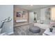 Comfortable bonus room featuring modern furniture, a textured accent wall, and a sliding door at 373 Fosterton Cottage Way, Raleigh, NC 27603