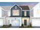 Charming two-story townhome with a two-car garage and inviting front porch, perfect for a starter home at 4004 Kidd Pl, Durham, NC 27703