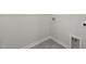 Clean and unfinished basement space with gray painted walls and tiled floors and utility hookups at 4006 Kidd Pl, Durham, NC 27703