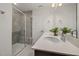 Modern bathroom featuring double sinks, a tile shower with bench, and sleek fixtures at 4008 Kidd Pl, Durham, NC 27703