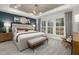 Primary bedroom featuring neutral decor, large windows, a tray ceiling and lots of natural light at 4008 Kidd Pl, Durham, NC 27703