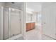 Bright bathroom featuring a tub, shower with glass door, and wood cabinets at 4038 Patriot Ridge Ct, Raleigh, NC 27610