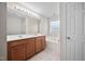 Neutral toned bathroom with a double sink vanity, soaking tub and large mirror at 4038 Patriot Ridge Ct, Raleigh, NC 27610
