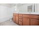 Bathroom with double sinks, vanity and shower/tub combination with natural light at 4038 Patriot Ridge Ct, Raleigh, NC 27610