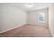 Neutrally painted bedroom featuring carpet flooring, window, and a closet for modern living at 4038 Patriot Ridge Ct, Raleigh, NC 27610