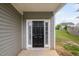Classic black front door with sidelights and white trim, inviting entrance at 4038 Patriot Ridge Ct, Raleigh, NC 27610