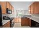 Well-lit kitchen with wooden cabinets and breakfast area with natural light at 4038 Patriot Ridge Ct, Raleigh, NC 27610