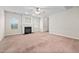 Bright living room showcasing a cozy fireplace, large windows, and carpet flooring at 4038 Patriot Ridge Ct, Raleigh, NC 27610
