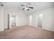 Spacious carpeted main bedroom with ceiling fan and multiple closets and entryways at 4038 Patriot Ridge Ct, Raleigh, NC 27610