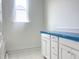 Bathroom with white cabinets, countertop, window and blue protective film at 47 Tee Time Ter, Benson, NC 27504