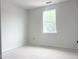 Bright bedroom with white trim, walls, and a large window at 47 Tee Time Ter, Benson, NC 27504
