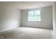 Bright bedroom with white trim, walls, and a large window at 47 Tee Time Ter, Benson, NC 27504