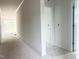 Bright hallway with white walls and trim, leading to a room with large windows at 47 Tee Time Ter, Benson, NC 27504