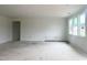 Spacious living room with large windows, white walls, and trim, ready for finishing touches at 47 Tee Time Ter, Benson, NC 27504