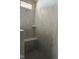 Modern walk in shower with gray walls, tile flooring, and a built in corner shelf at 50 Rainfall Dr, Pittsboro, NC 27312
