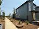 Home exterior showing mulched plantings and a gray sidewalk running along the home's length at 50 Rainfall Dr, Pittsboro, NC 27312