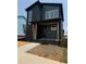 New construction home featuring a dark painted brick foundation and siding with many large windows at 50 Rainfall Dr, Pittsboro, NC 27312