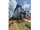 Modern two-story home with landscaping, a gray exterior, and an 'Available' sign in the front yard at 50 Rainfall Dr, Pittsboro, NC 27312