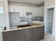 Unfinished kitchen with white cabinets, an island base, and a pantry with shelving at 50 Rainfall Dr, Pittsboro, NC 27312
