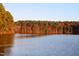 Scenic lake view surrounded by colorful fall foliage, providing a tranquil and picturesque natural setting at 5057 Lundy Dr # 101, Raleigh, NC 27606