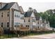 Back view of stylish new homes featuring decks and fenced yards for outdoor enjoyment at 5057 Lundy Dr # 101, Raleigh, NC 27606