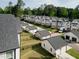 An aerial shot of well-maintained gray and white two-story homes with manicured lawns at 5057 Lundy Dr # 101, Raleigh, NC 27606