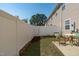 Fenced backyard with small patio area, green grass, mature trees, and outdoor seating at 5210 Blue Lagoon Ln, Raleigh, NC 27610