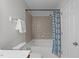 Full bathroom with tub and tiled shower behind a colorful shower curtain at 5210 Blue Lagoon Ln, Raleigh, NC 27610